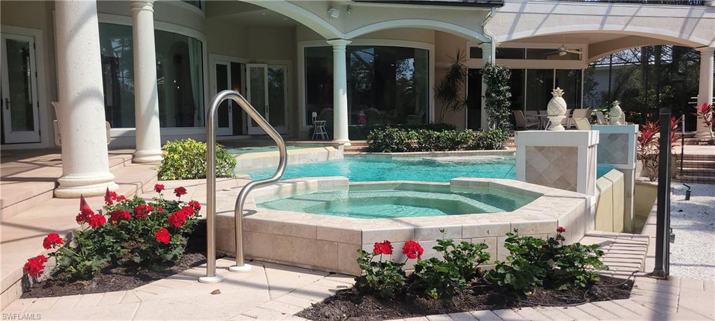 1269 Pocantico Lane Naples, FL 34110 - Photo 5 of 45 a view of a house with tub and flowers in front