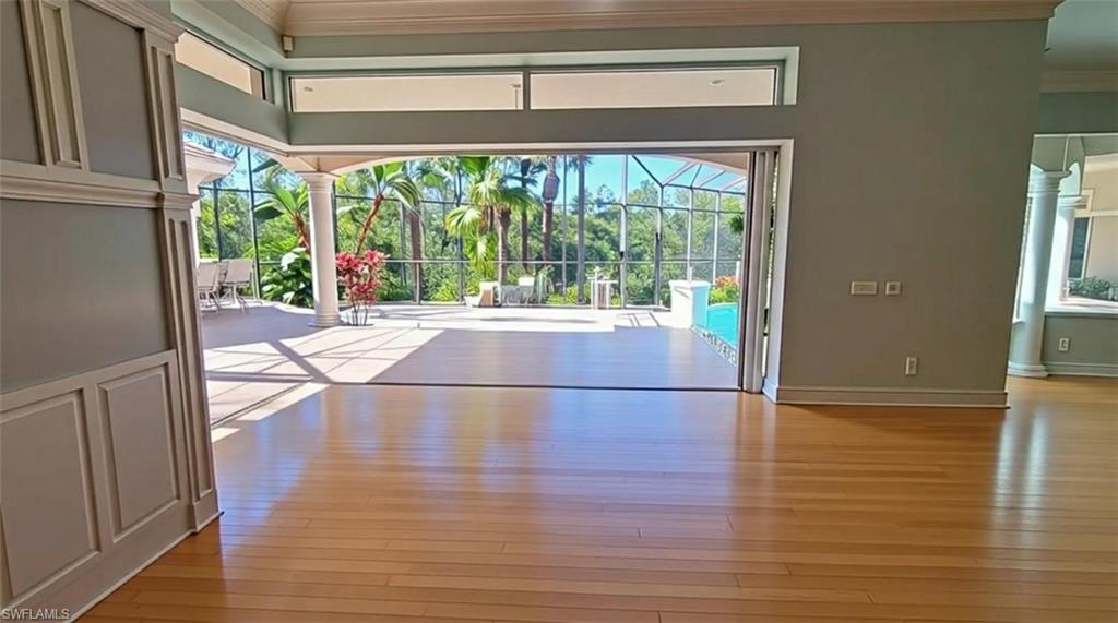 1269 Pocantico Lane Naples, FL 34110 - Photo 7 of 45 a view of empty room with wooden floor and fan