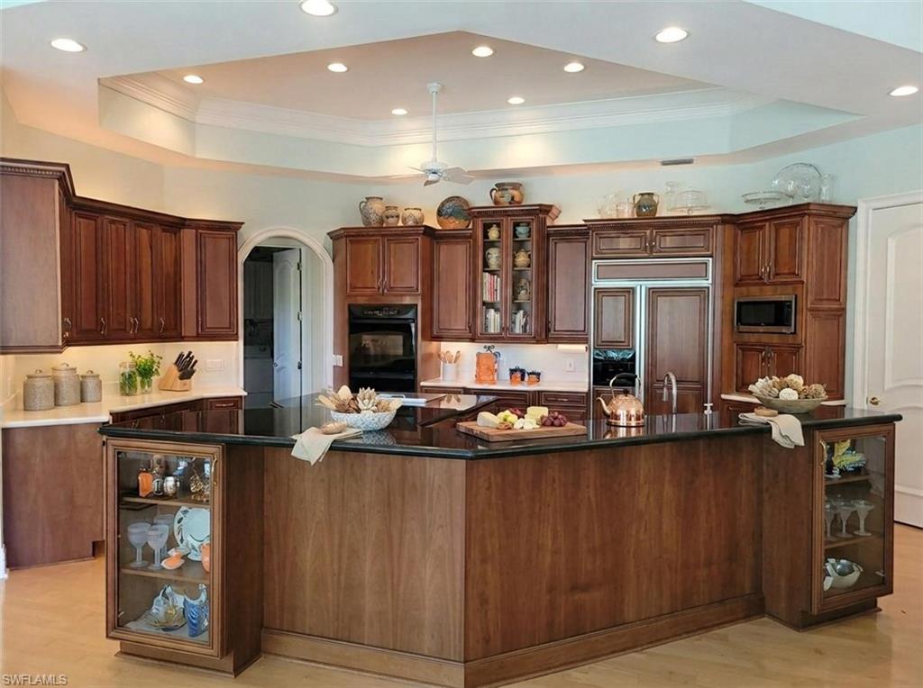 1269 Pocantico Lane Naples, FL 34110 - Photo 9 of 45 a kitchen with stainless steel appliances granite countertop a refrigerator and a stove