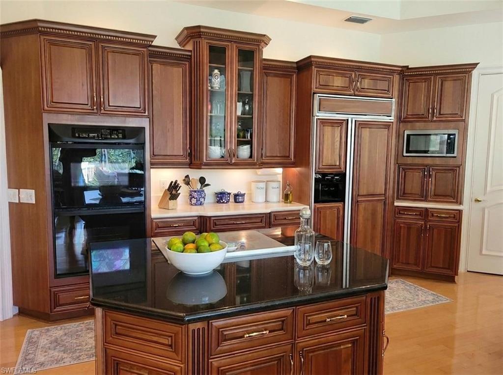1269 Pocantico Lane Naples, FL 34110 - Photo 10 of 45 a kitchen with stainless steel appliances granite countertop a refrigerator and a stove