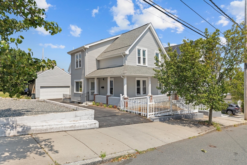15 Bennett Street Everett, MA 02149 - Photo 1 of 39 a front view of a house with yard and trees