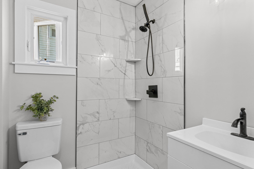 15 Bennett Street Everett, MA 02149 - Photo 12 of 39 a bathroom with a toilet sink and shower