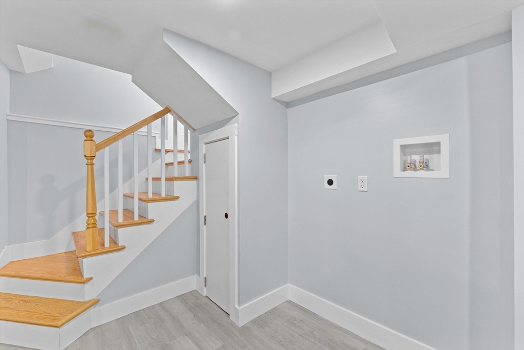 15 Bennett Street Everett, MA 02149 - Photo 14 of 39 a view of entryway with stairs and wooden floor