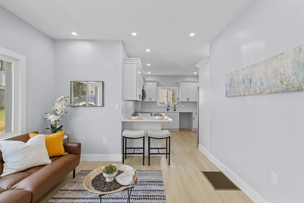 15 Bennett Street Everett, MA 02149 - Photo 3 of 39 a living room with furniture and a table
