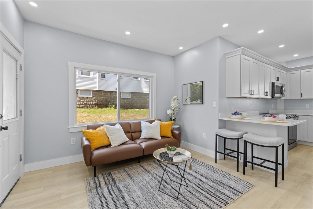 15 Bennett Street Everett, MA 02149 - Photo 4 of 39 a living room with furniture and a table