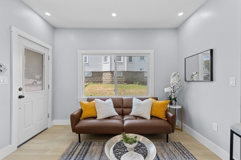 15 Bennett Street Everett, MA 02149 - Photo 5 of 39 a living room with furniture and a table