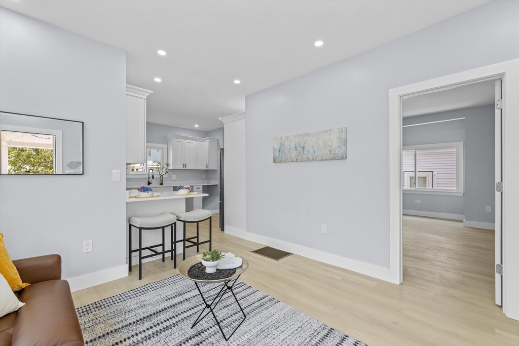 15 Bennett Street Everett, MA 02149 - Photo 7 of 39 a view of kitchen with furniture and wooden floor