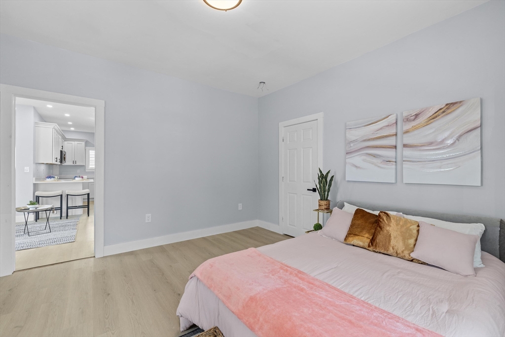 15 Bennett Street Everett, MA 02149 - Photo 10 of 39 a bedroom with a bed and a chair