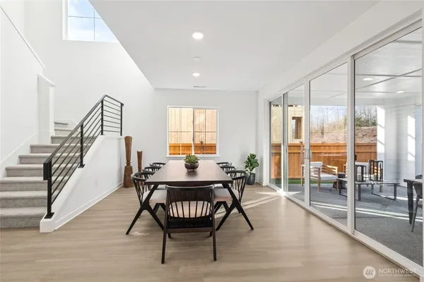 a dining room with furniture and wooden floor
