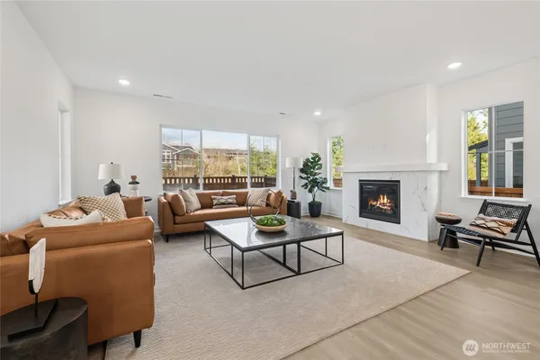 a living room with furniture and kitchen view
