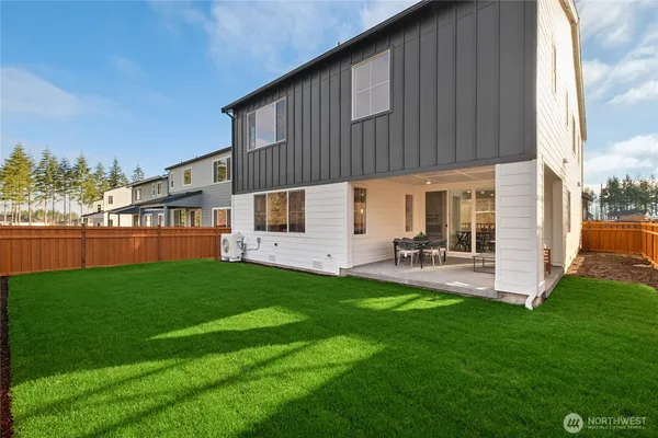 a backyard of a house with table and chairs
