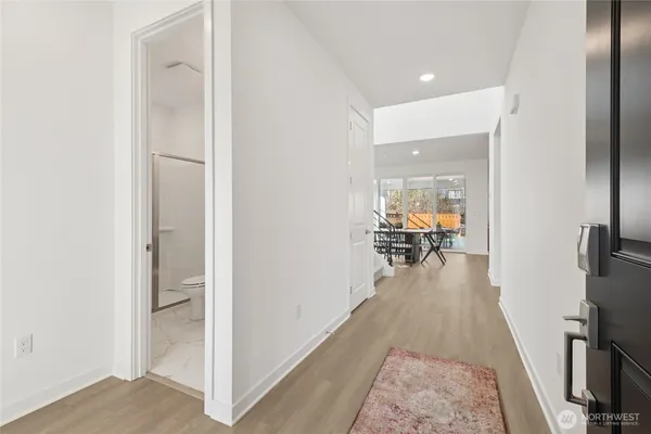 a hallway with a dining table and chairs