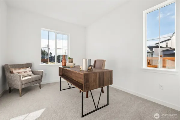 a work room with furniture and windows
