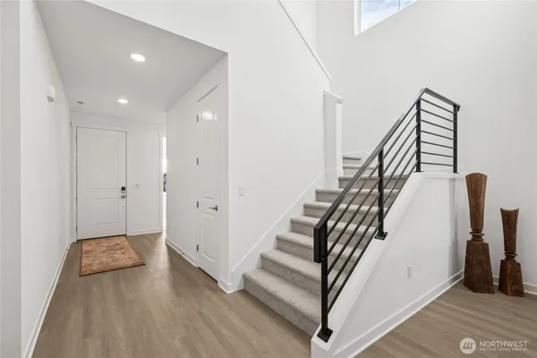 a view of entryway and hall with wooden floor