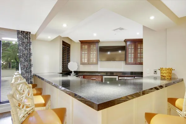a kitchen with stainless steel appliances granite countertop a sink and a white cabinets