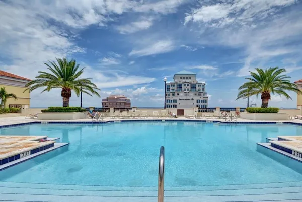 a view of a swimming pool and an outdoor seating