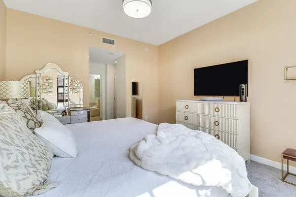 a bedroom with a bed and a flat screen tv