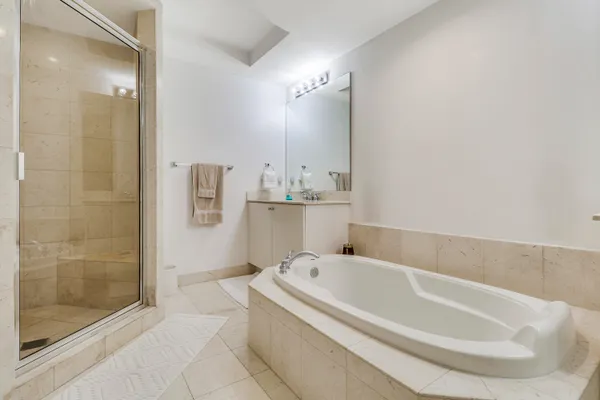 a white bath tub sitting in a bathroom and shower