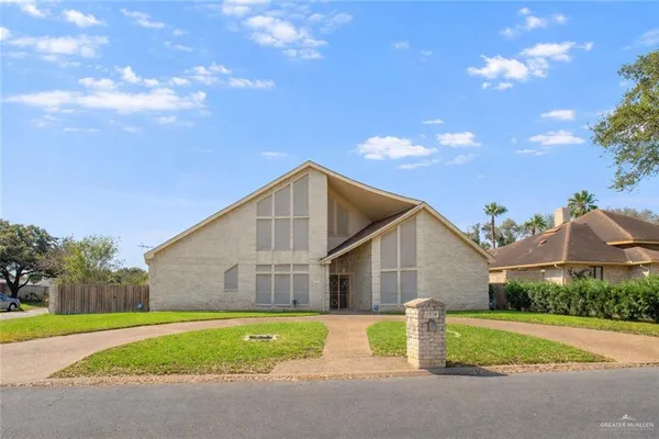 a view of a house with a yard and garage