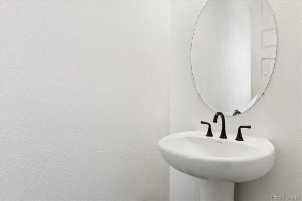 a bathroom with a sink a mirror and vanity