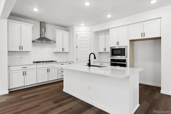 a kitchen with stainless steel appliances a stove refrigerator sink and cabinets