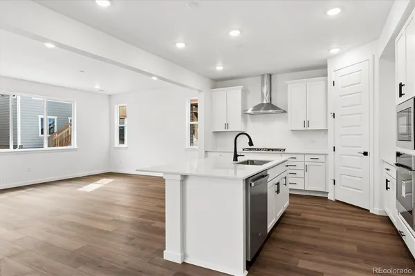 a kitchen with stainless steel appliances granite countertop a stove and a sink