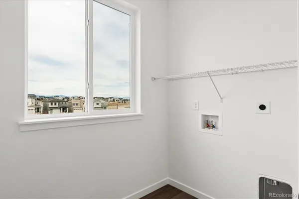 a view of a small space with wooden floor and a window