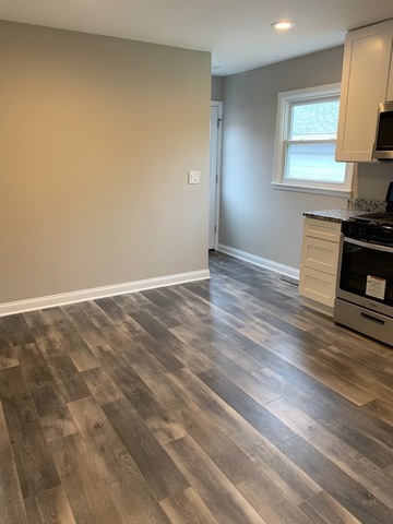 535 Willow Road Wauconda, IL 60084 - Photo 3 of 17 a view of empty room with wooden floor and fan