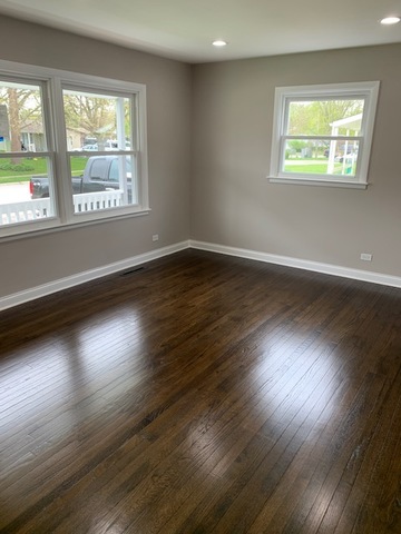 535 Willow Road Wauconda, IL 60084 - Photo 5 of 17 a view of an empty room with wooden floor and a window