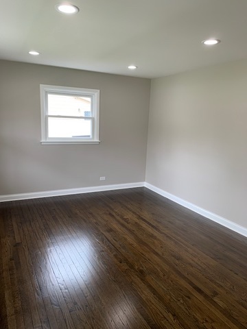 535 Willow Road Wauconda, IL 60084 - Photo 7 of 17 a view of an empty room with wooden floor and a window