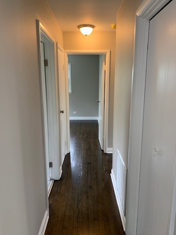 535 Willow Road Wauconda, IL 60084 - Photo 9 of 17 a view of a hallway with wooden floor and staircase