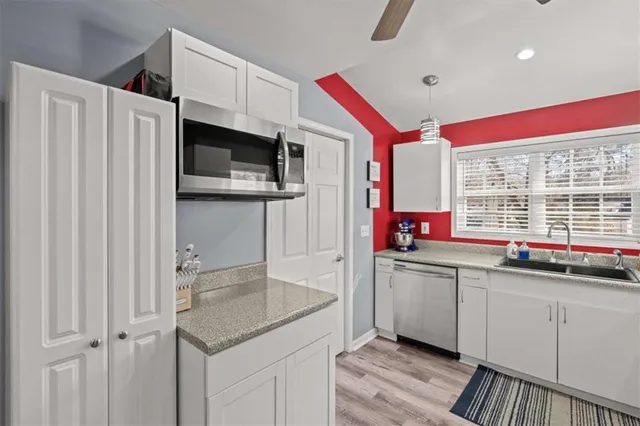 a living room with a chair and a potted plant