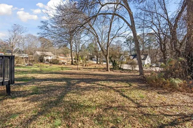 a front view of house with yard and trees around