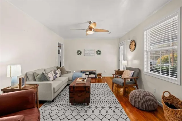 a living room with furniture rug and window