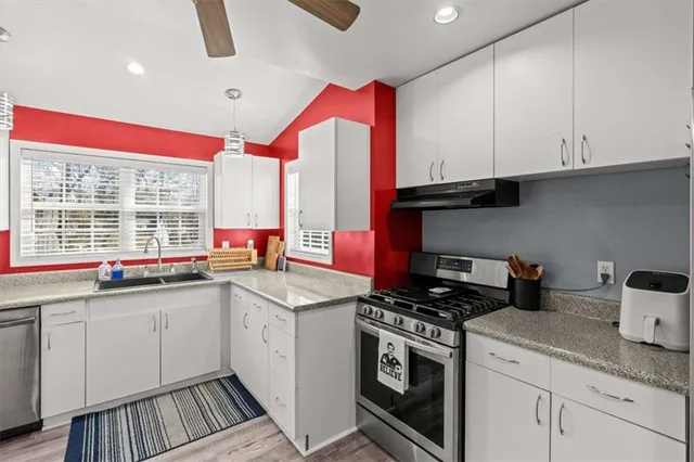 a kitchen with a sink cabinets and window