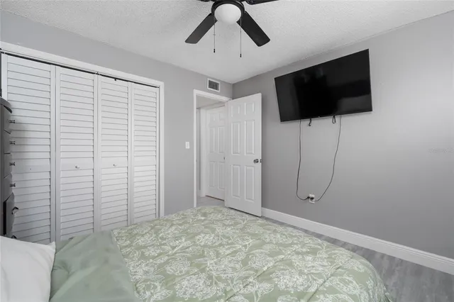a view of a livingroom with an empty space tv and a ceiling fan