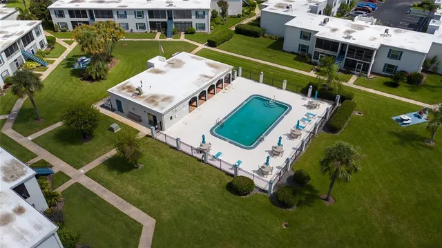 an aerial view of a house with a garden and swimming pool