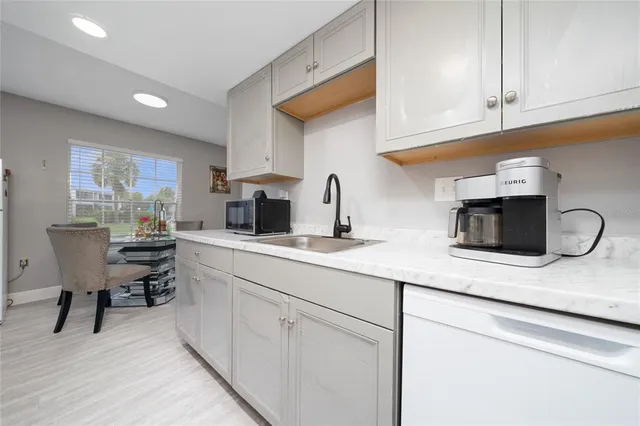 a kitchen with stainless steel appliances granite countertop a sink and cabinets