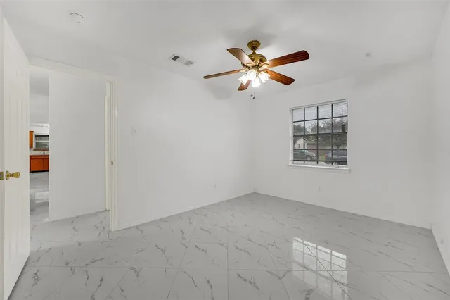 a white toilet sitting next to a bathroom sink and a shower