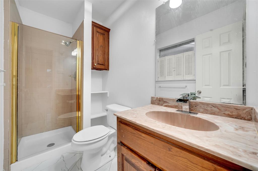 4610 Bucknell Drive Garland, TX 75042 - Photo 15 of 25 a bathroom with a sink toilet and shower