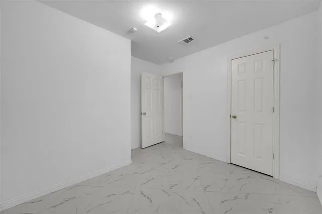 a view of an empty room with sliding glass door