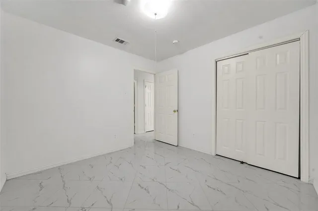 a view of an empty room with sliding glass door