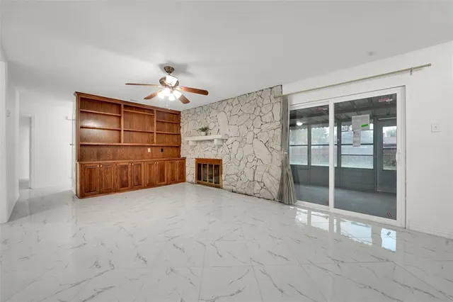 a living room with furniture and a ceiling fan