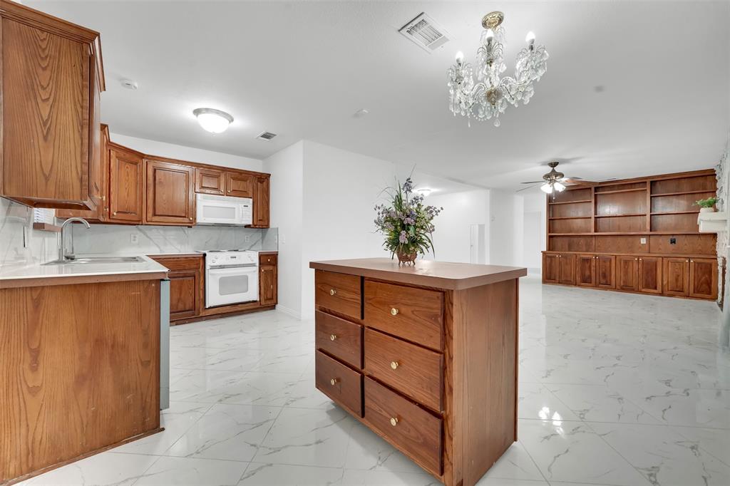 4610 Bucknell Drive Garland, TX 75042 - Photo 10 of 25 a kitchen with stainless steel appliances granite countertop a stove a sink and a microwave