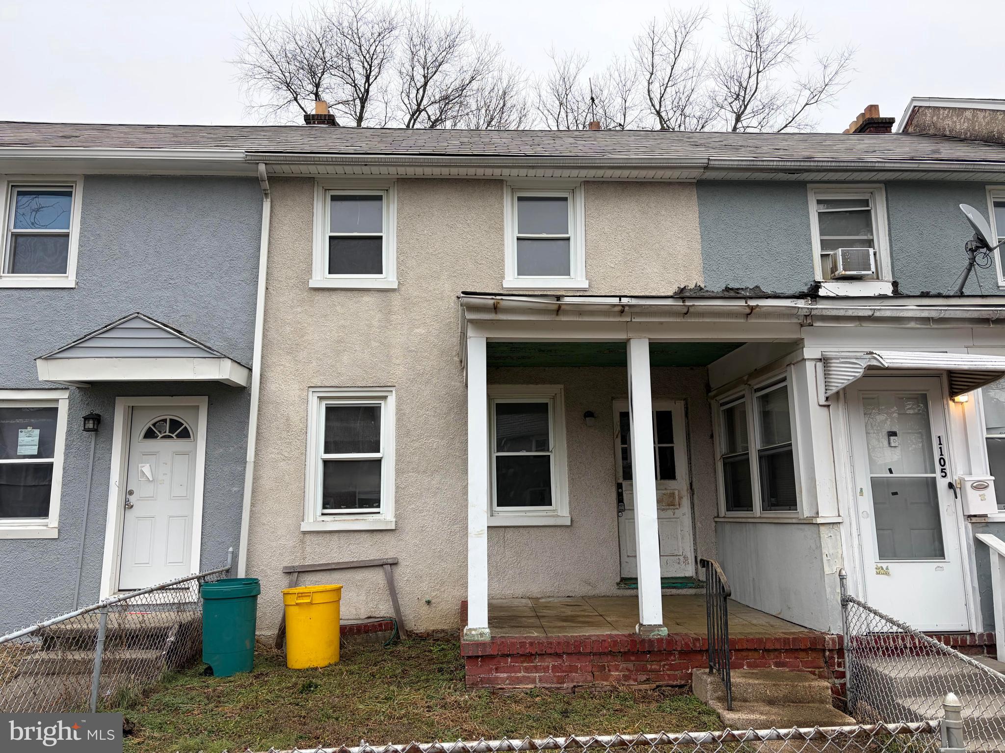 a front view of a house with a tree