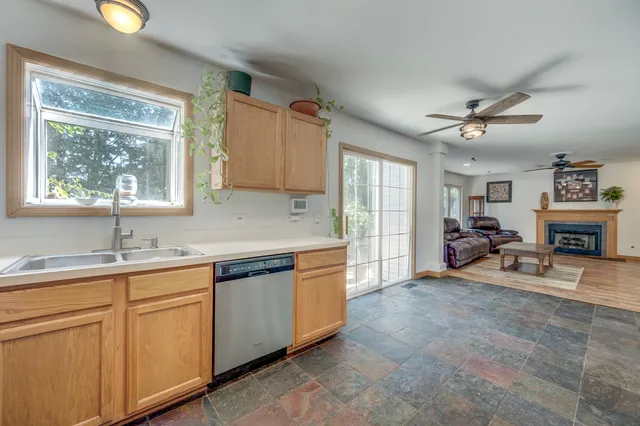a very nice looking kitchen with a large window cabinets and stainless steel appliances