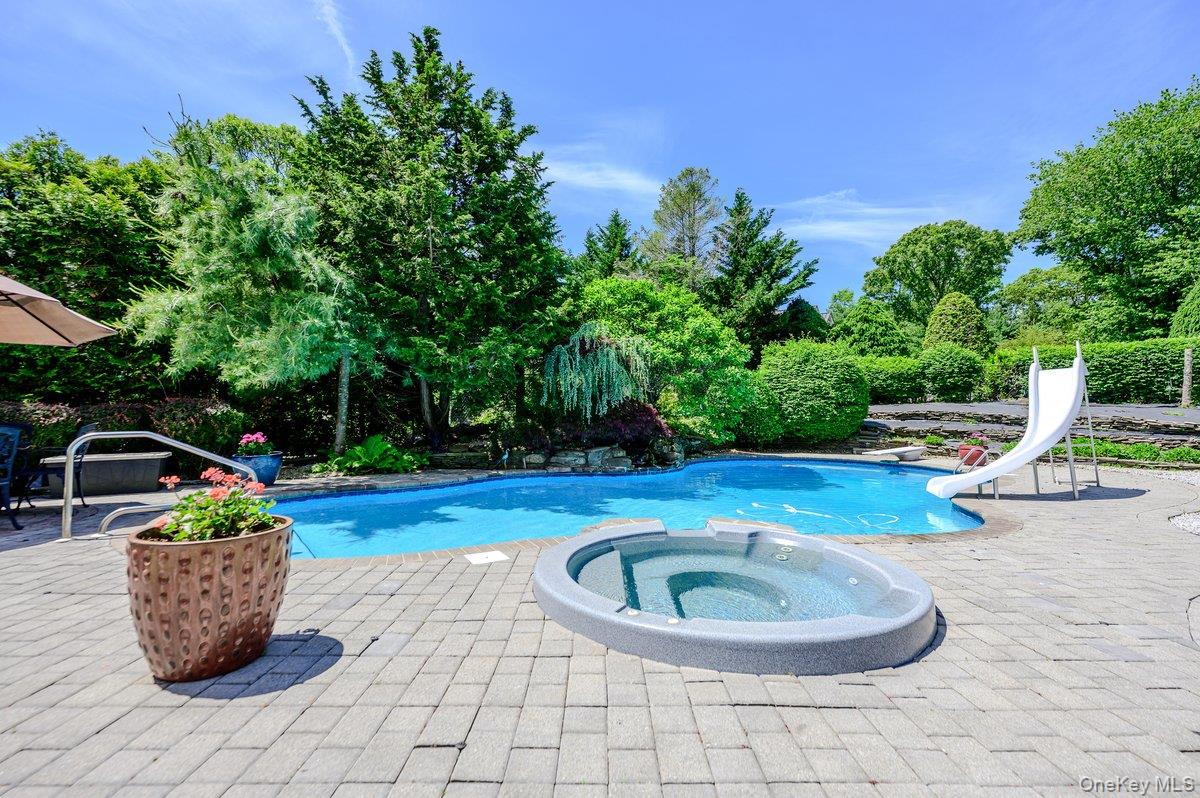 129 Round Swamp Road Huntington, NY 11743 - Photo 43 of 49 Outdoor leisure area featuring a freeform swimming pool, integrated spa, and extensive paver patio