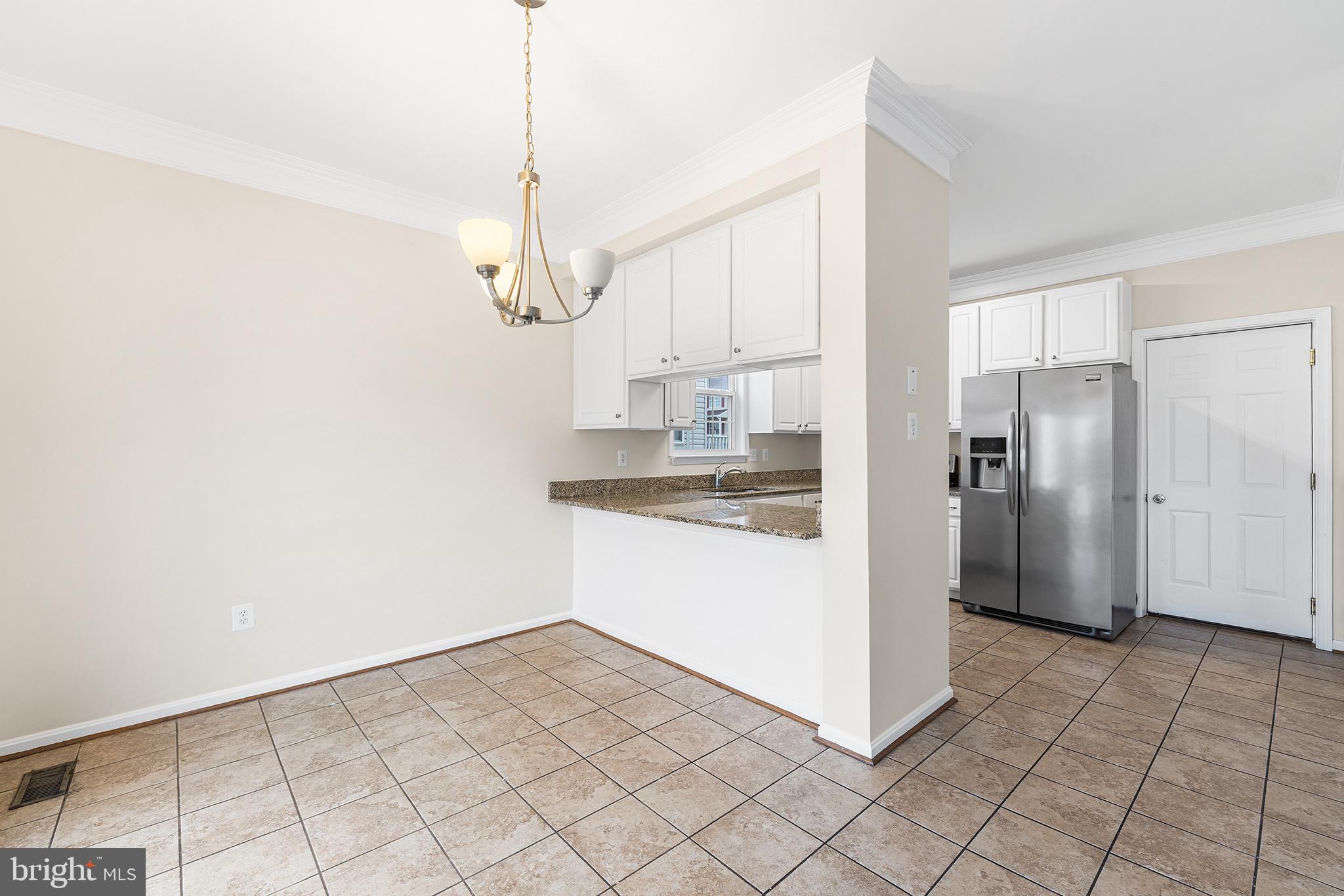 31 Dunmore Drive Hanover, PA 17331 - Photo 13 of 55 a kitchen with kitchen island granite countertop white cabinets a refrigerator and a counter top