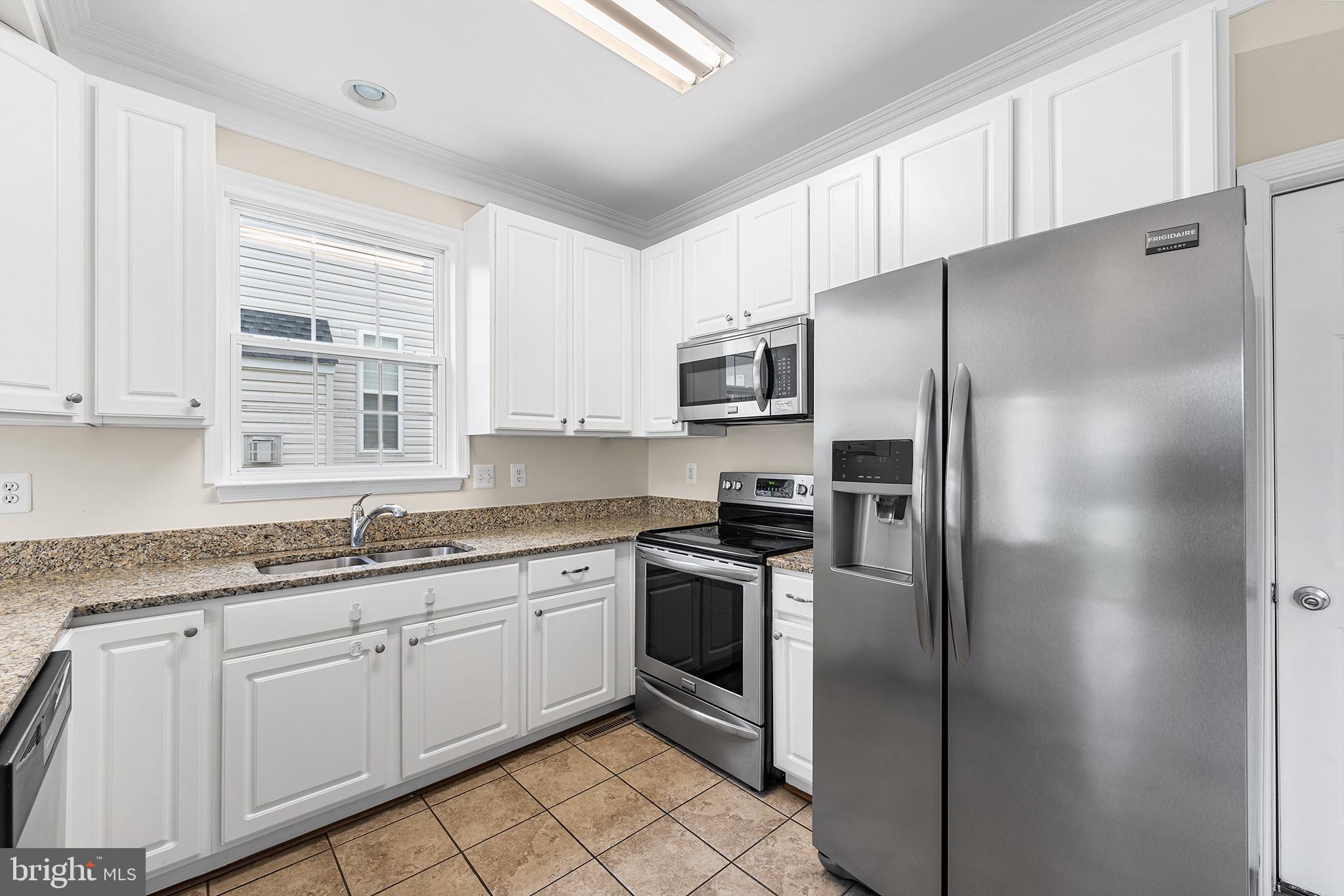 31 Dunmore Drive Hanover, PA 17331 - Photo 15 of 55 a kitchen with stainless steel appliances granite countertop a refrigerator a sink a stove a microwave and island