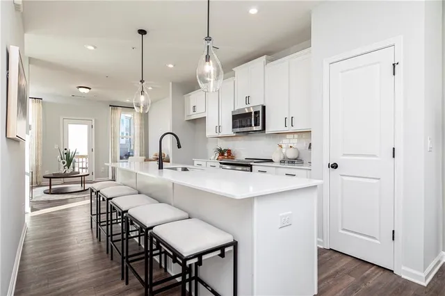 a kitchen with appliances a sink and cabinets